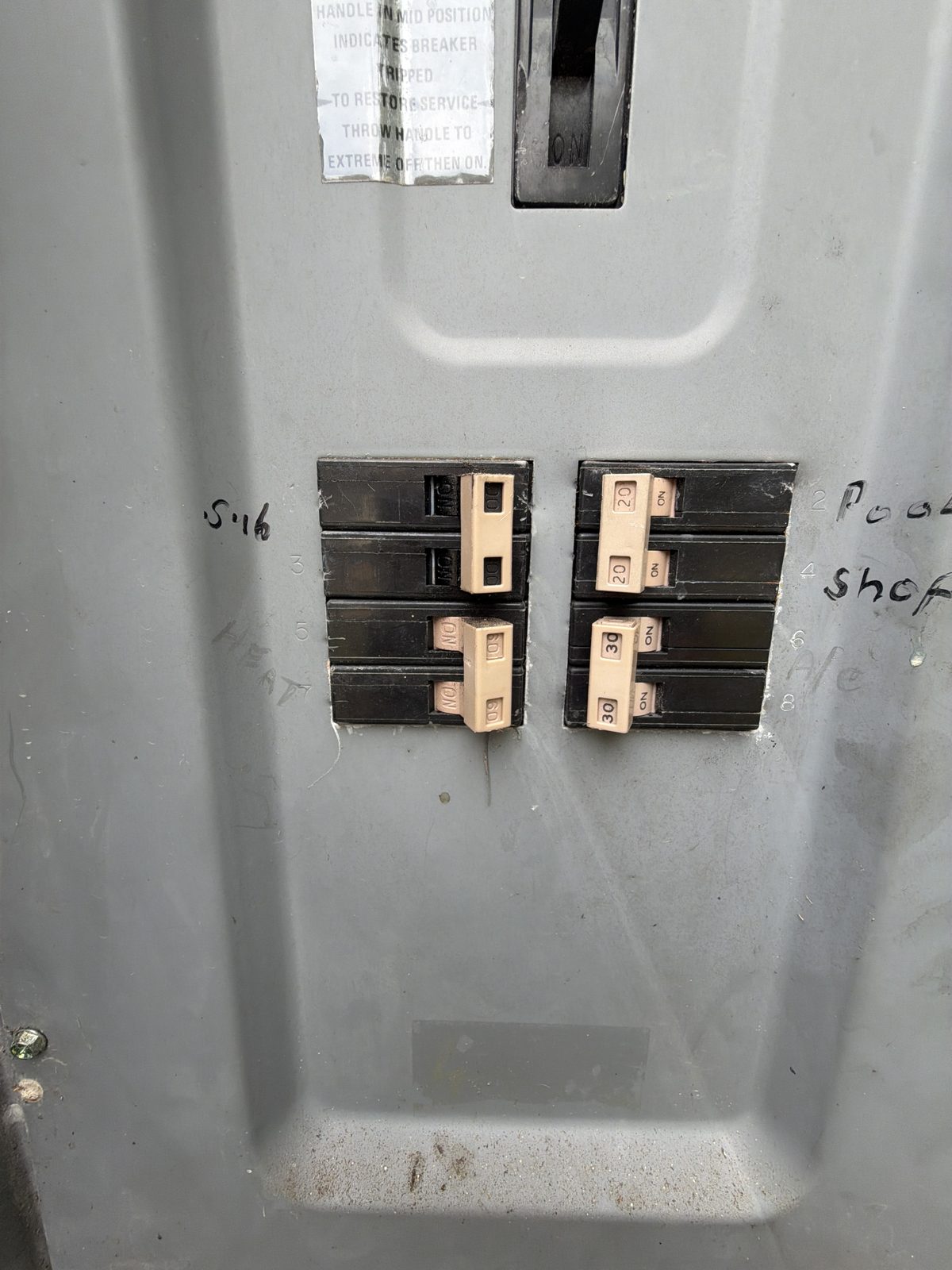 Checking breaker sizing in the electrical panel during an HVAC replacement estimate in DeBary