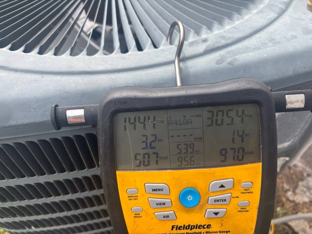 Manifold gauge verifying R-410A refrigerant charge during AC maintenance in Sanford