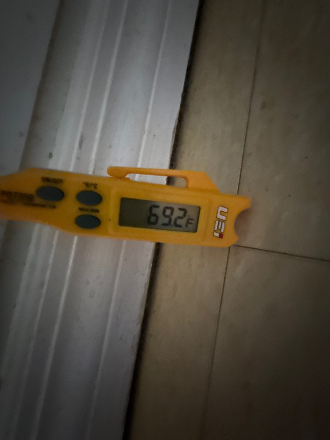 Thermometer reading 69.2 degrees at a supply register during an AC checkup in Deltona