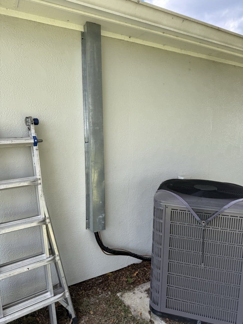 New refrigerant line set running down the wall to the outdoor unit at Bob's Deltona home