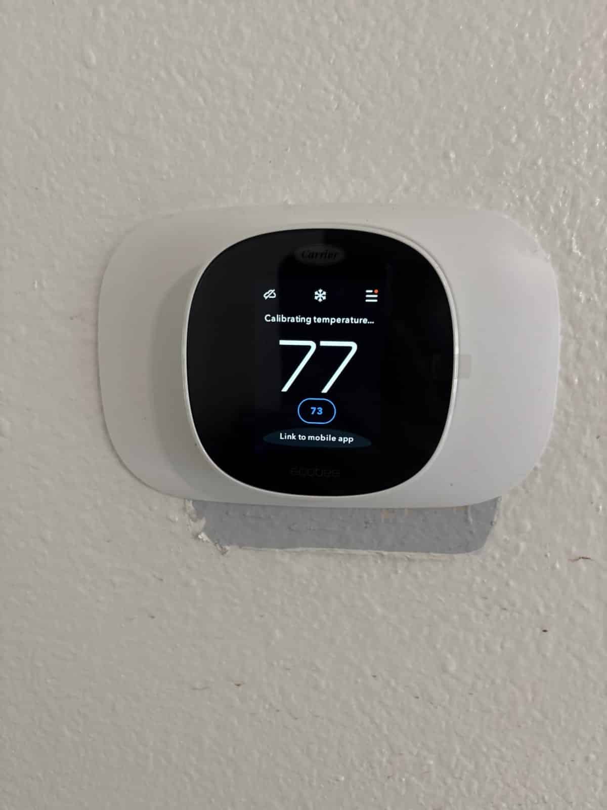 Joe's new smart thermostat on the wall of his Deltona home